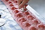 Red ravioli being made