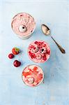 Strawberry ice, cherry ice cream and raspberry ice cream in metal cups (seen from above)