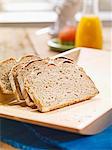 Sliced rye bread on a flat wooden tray