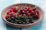 Various summer fruits in a wooden bowl