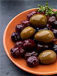 Olives in an orange dish (tapas)
