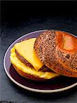 Sausage, egg and cheese breakfast sandwich on a poppy seed bagel