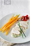 Steamed chicken breast with carrots on a creamy avocado sauce