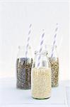 Chia, sunflower seeds and quinoa in milk bottles