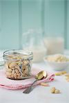 A jar of shelled almonds and a jug of almond milk