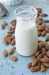 A bottle of almond milk and almonds