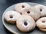 Raspberry-filled biscuits dusted with icing sugar
