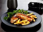 pork and ale sausages with french fries and watercress