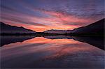 Natural reserve of Pian di Spagna flooded with snowy peaks reflected in the water at sunset, Valtellina, Lombardy, Italy, Europe