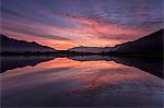 Natural reserve of Pian di Spagna flooded with snowy peaks reflected in the water at sunset, Valtellina, Lombardy, Italy, Europe