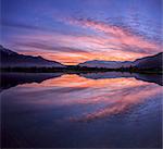 Panoramic view of Pian di Spagna flooded with snowy peaks reflected in the water at sunset, Valtellina, Lombardy, Italy, Europe