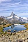 Hikers admire the Matterhorn reflected in Lake Stellisee, Zermatt, Canton of Valais, Pennine Alps, Swiss Alps, Switzerland, Europe