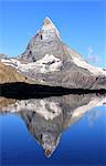 Hiker admiring the Matterhorn reflected in Lake Stellisee, Zermatt, Canton of Valais, Pennine Alps, Swiss Alps, Switzerland, Europe
