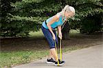 Mature woman resistance training in park