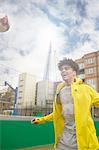 Young man playing football on urban football pitch