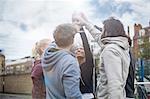 Group of adults, touching hands, outdoors