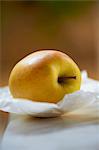 Yellow apple on greaseproof paper