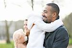 Side view of smiling father carrying daughter