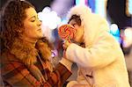 Mother and daughter enjoying lollipop