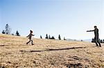 Female toddler running to father on hill, Tegernsee, Bavaria, Germany