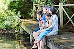 Family sitting at the edge of dock