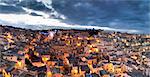 Scenic overview of congested houses of Sassi di Matera illuminated at dusk, one of the three oldest cities in the world, Matera, Basilicata, Italy