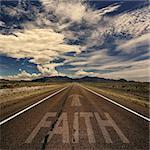 Conceptual image of desert road with the word faith and arrow