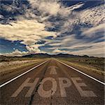 Conceptual image of desert road with the word hope and arrow