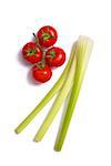 Bunch of fresh tomatoes and celery sticks, top view isolated on white background