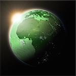 Sun over Africa on green planet Earth isolated on black background. Highly detailed planet surface. Elements of this image furnished by NASA.