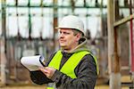 Electrical Engineer with folder in the electric substation