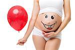 On the belly of pregnant women smiley face baby and red balloon