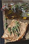 Making fragrant rosemary oil with olive oil and fresh herbs