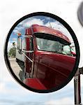 US manufactured semi-truck reflected in truck mirror