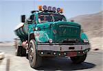 Vintage Egyptian water tanker truck racing thru desert with speed blur