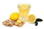 Cold and flu remedy drink in glass with fresh ginger, lemon and honey over white background.