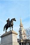 LONDON, UK - DECEMBER 19: Statue of King George IV in Trafalgar Square with Saint Martin in the Fields church in the background. December 19, 2015 in London.