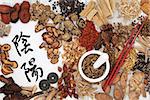 Yin and yang symbols with traditional chinese herbal medicine selection, i ching coins, mortar with pestle and chopsticks.