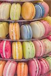 Macarons in different colors and flavors, displayed on an etagere