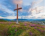 Summer evening country foothills view with heather flowers and wooden cross (Lviv Oblast, Ukraine) .
