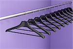 Plastic hangers hanging on rod in the closet