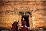 Young Buddhist novice monks at outside monastery, pagan, Myanmar.