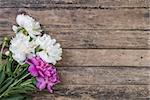 Peony flowers on wooden boards, rustic background