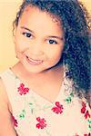 Instagram style filter photograph of a beautiful young mixed race African American girl smiling and looking happy