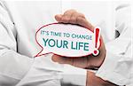 Image of a man hand holding speech bubble with the text it is time to change your life, white shirt. Conceptual message for motivation and goal achievement.