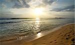 Beautiful sunset over sandy beach of Indian ocean