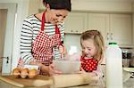 Mother and daughter baking cookies together