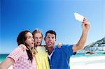 Cute family taking a selfie on the beach