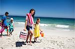 Cute family walking on the beach