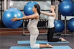 Women exercising with fitness ball at the leisure center